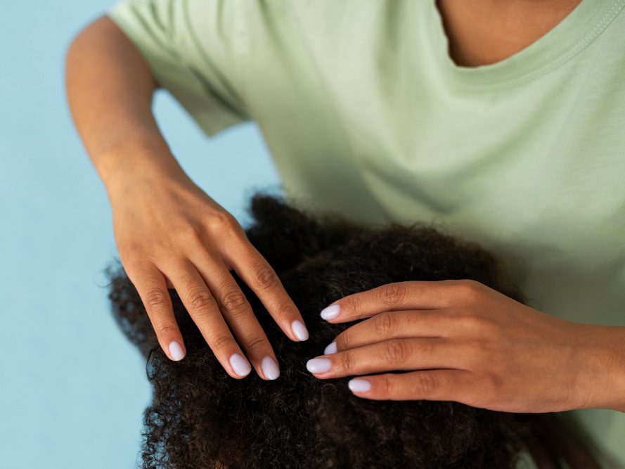 A scalp massage being done on healthy type 4 hair