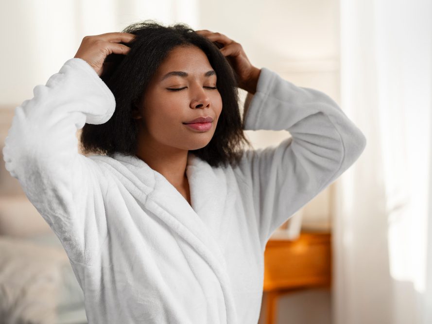 Woman giving herself a scalp massage